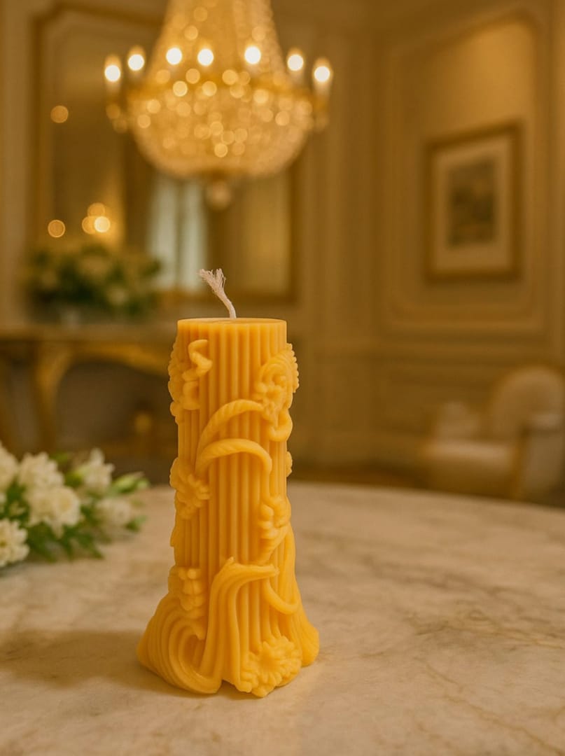 Ornate carved yellow pillar candle in an elegant interior setting
